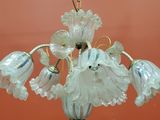 a glass chandelier hanging from the ceiling in a room