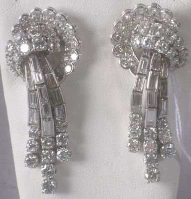 pair of diamond and white gold earrings on display on a mannequin
