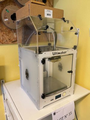 a white machine sitting on top of a white table