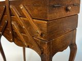 a small wooden table with two drawers on it