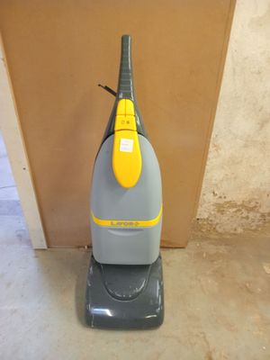 an image of a vacuum cleaner in the corner of a room