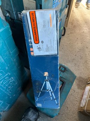 a box with a picture of a man standing on a tripod