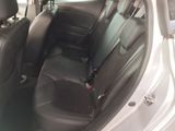 the back seats of a white car with a black seat belt