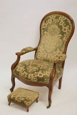 an image of a green and gold chair with a foot stool