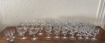 many empty wine glasses sitting on a wooden table