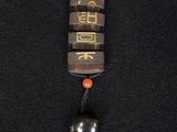 a close up of a small wooden book with a bell hanging from it