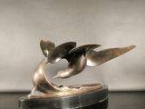 a sculpture of a bird that is on top of a table