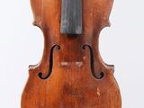 an old violin sitting on a white surface with a white background