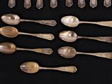 a lot of spoons and spoon spoons on a black surface