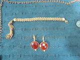 a picture of a necklace, bracelet, and earrings on a table