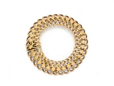 gros plan d'un bracelet en chaîne en or sur fond blanc