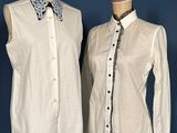 two mannequins with shirts and ties on display against a blue wall