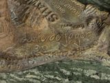 a close up of a bronze statue of a horse
