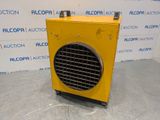 a close up of a yellow heater sitting on top of a floor