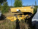 a yellow truck that is parked in the grass