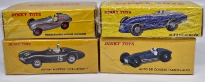 three boxed toy cars sitting on top of each other on a table