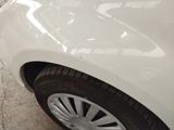 a white car that is parked in a parking lot