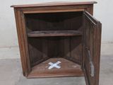 a small wooden cabinet with a cross painted on it
