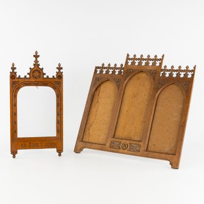 two pieces of wood with carvings and a mirror on a white surface