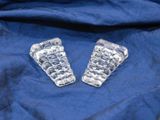 pair of clear glass buttons on a blue cloth