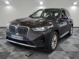 the bmw x1 is parked in a large room with a checkered floor