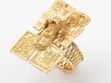 an image of a gold ring with a statue on it