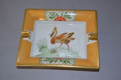 a yellow plate with a picture of a flamingo on it