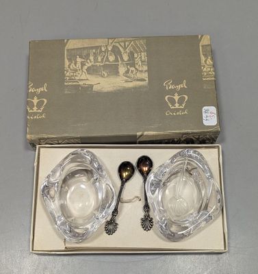 deux cuillères en argent et un saladier en verre dans une boîte