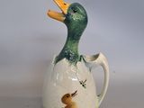 a small ceramic duck that is sitting on a table