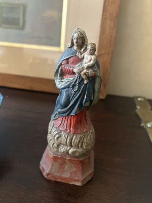 a figurine of a woman holding a child on a table