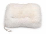 a close up of a white fur pillow on a white background