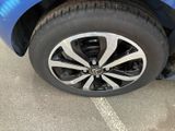 a close up of a tire on a blue car