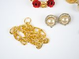 many different types of jewelry on a white surface