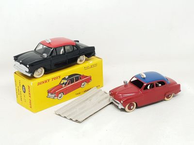 two toy cars sitting next to each other on a white surface