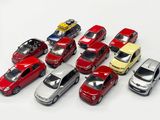 several toy cars are lined up in a row on a white surface