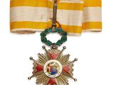 une image d'une médaille entourée d'un ruban sur fond blanc
