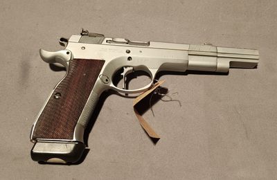 a gun that is laying on the floor with a tag