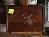 a wooden table with a vase on top of it