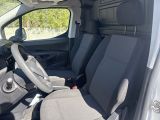 the interior of a van with a steering wheel and seat covers