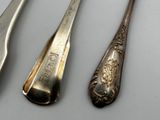 four spoons and two spoons on a table