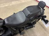 a black motorcycle with a black seat and a black handlebar