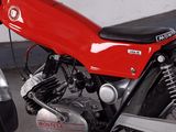 a red motorcycle parked next to a silver car