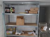 a room with shelves and boxes on the floor