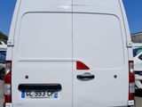 the back end of a white van parked in a parking lot