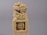 chinese carved ivory figurine of a lion on a pedestal