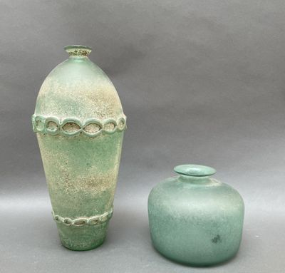 two vases sitting next to each other on a table