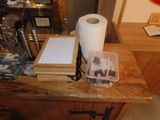 a picture of a kitchen counter with a roll of toilet paper on top of it