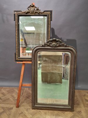 pair of antique mirrors on a wooden easel in front of a gray wall