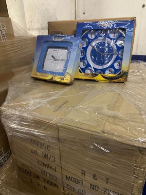 a pile of boxes with a clock on top of it