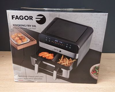 the box of the air fryer is open on the table